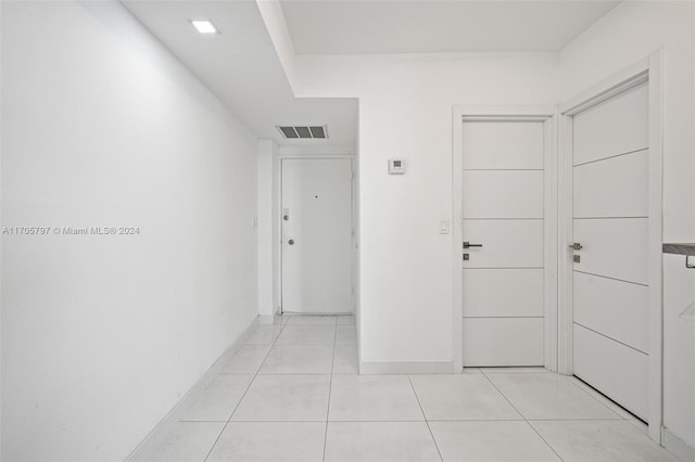 hall with light tile patterned floors