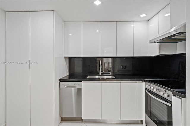 kitchen with backsplash, white cabinetry, sink, and appliances with stainless steel finishes