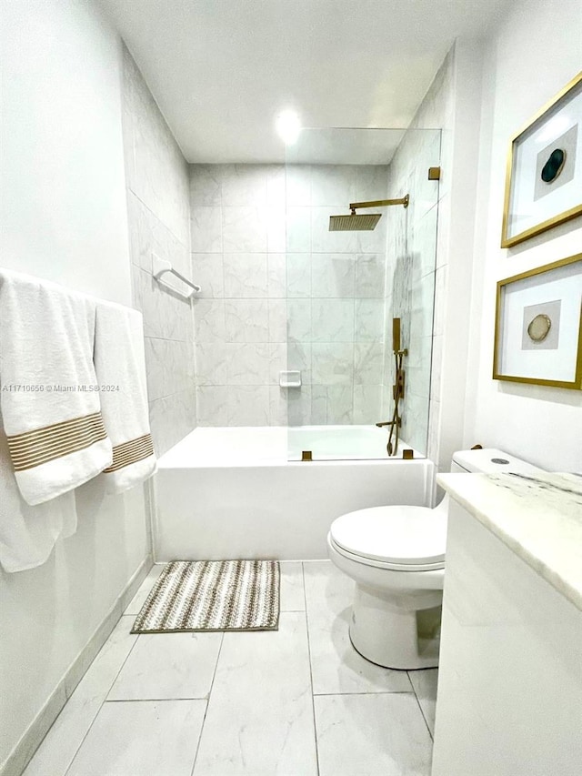 full bathroom featuring tiled shower / bath combo, toilet, and vanity