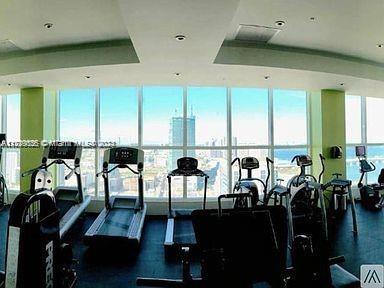 exercise room with plenty of natural light and floor to ceiling windows