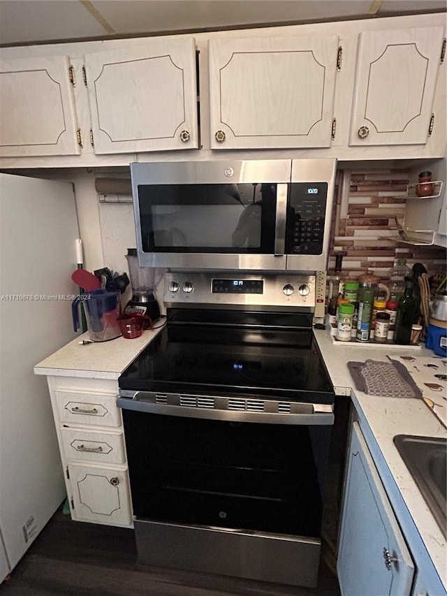 kitchen featuring backsplash, white cabinetry, sink, and stainless steel appliances