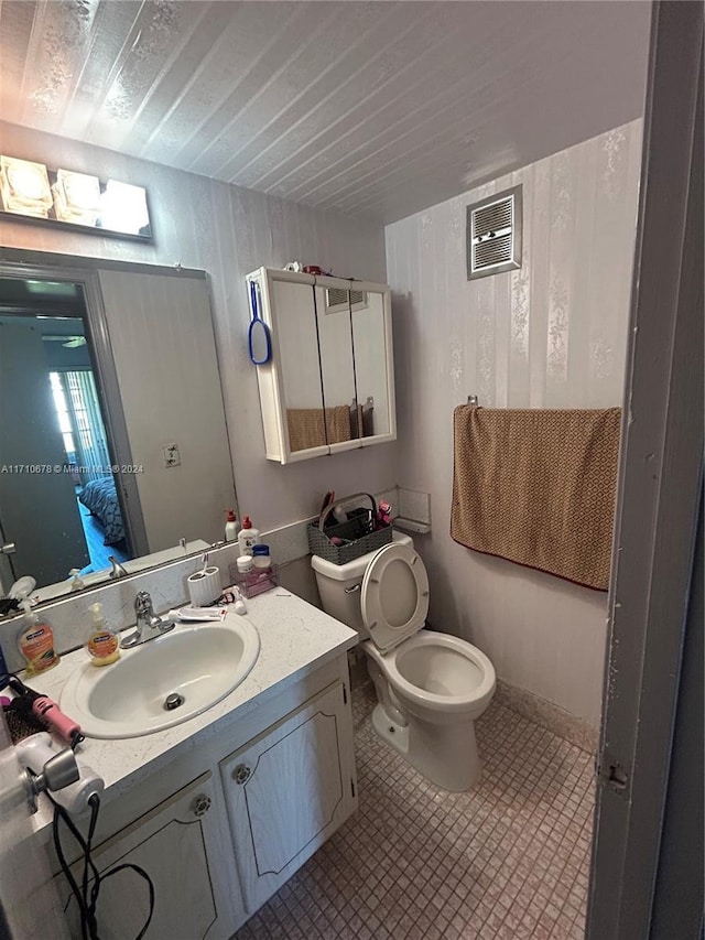 bathroom featuring vanity and toilet