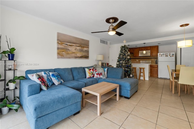 living room with ceiling fan and light tile patterned flooring