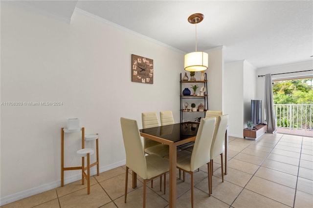 dining space featuring light tile patterned flooring and ornamental molding