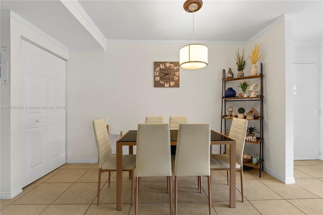 dining room featuring light tile patterned floors and ornamental molding