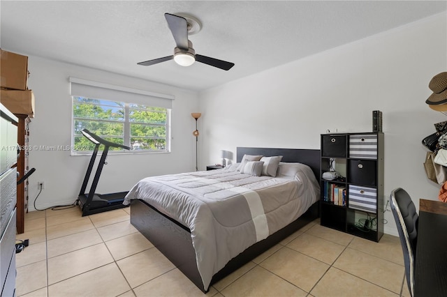 tiled bedroom featuring ceiling fan