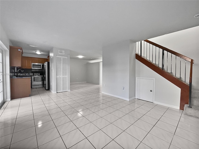 unfurnished living room featuring light tile patterned floors