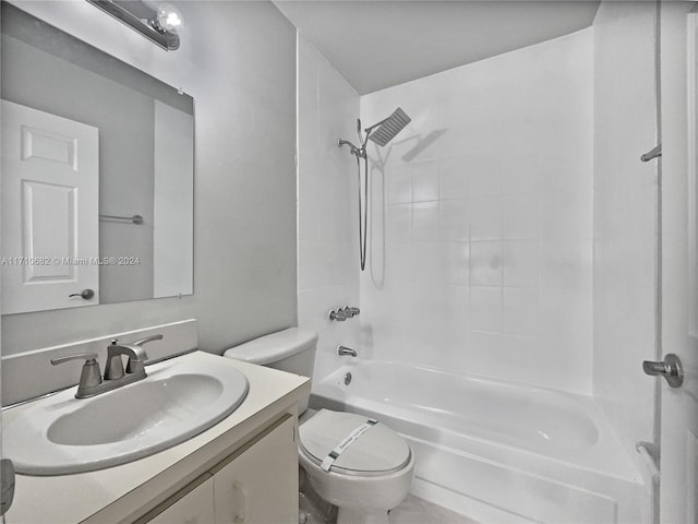 full bathroom featuring toilet, vanity, and tiled shower / bath