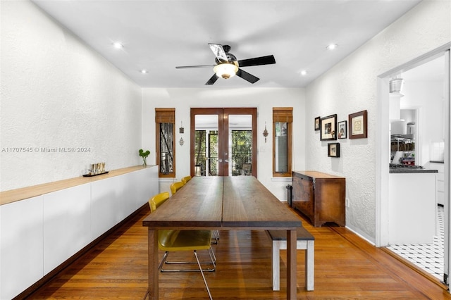 dining room with ceiling fan, french doors, and hardwood / wood-style flooring