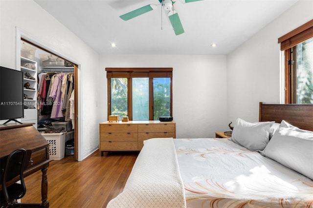 bedroom with multiple windows, ceiling fan, a closet, and light wood-type flooring