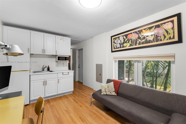 living room with sink and light wood-type flooring