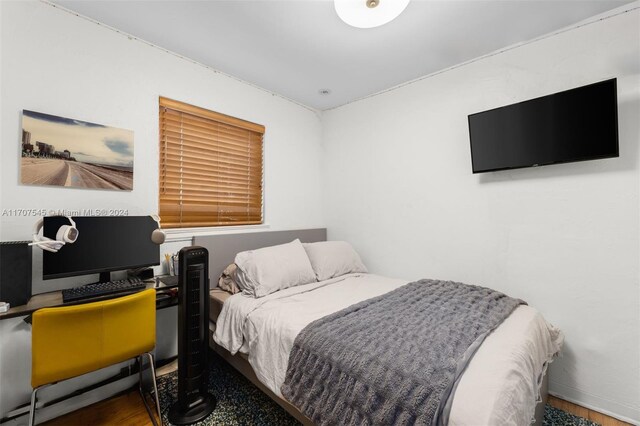 bedroom with dark hardwood / wood-style floors