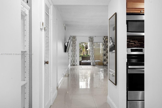 corridor featuring light tile patterned floors