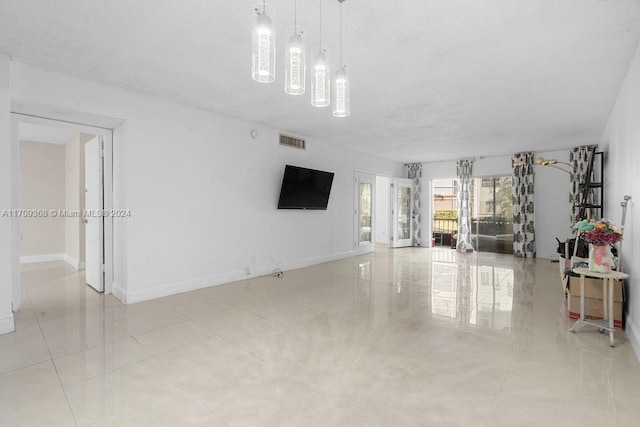 3330 Spanish Moss Ter Unit 109, Lauderhill, FL 33319 - living area featuring a textured ceiling, a chandelier, and light tile patterned floors