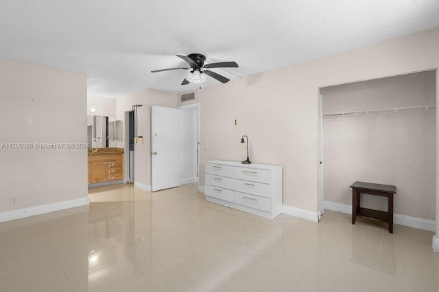 3330 Spanish Moss Ter Unit 109, Lauderhill, FL 33319 - unfurnished bedroom featuring a closet, light tile patterned flooring, a ceiling fan, and connected bathroom