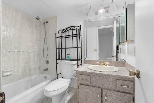 full bathroom featuring a textured ceiling, vanity, tile patterned flooring, toilet, and tiled shower / bath