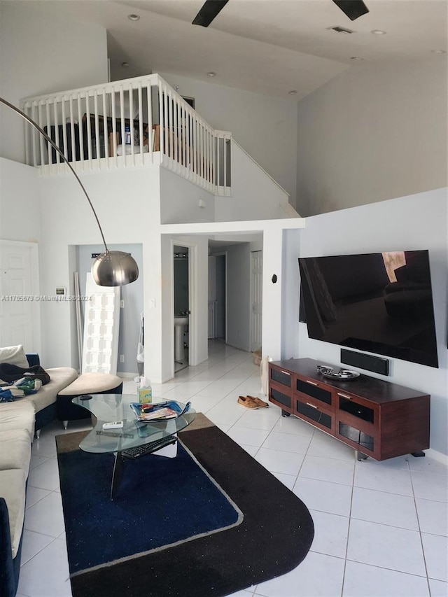 living room with a high ceiling and light tile patterned floors