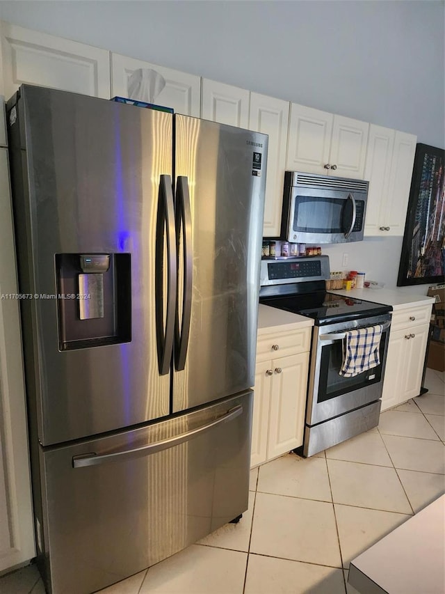 kitchen featuring light tile patterned floors, white cabinetry, and appliances with stainless steel finishes