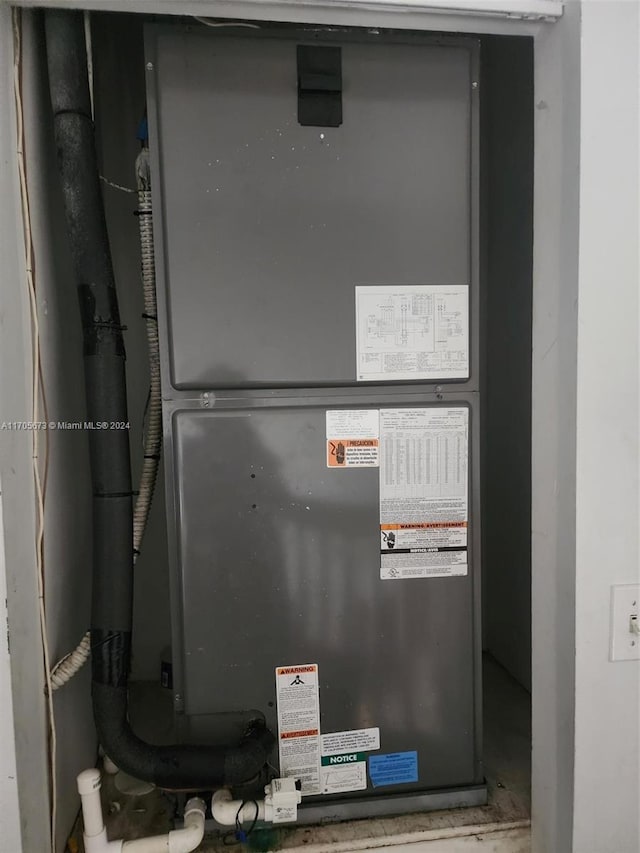 utility room featuring heating unit