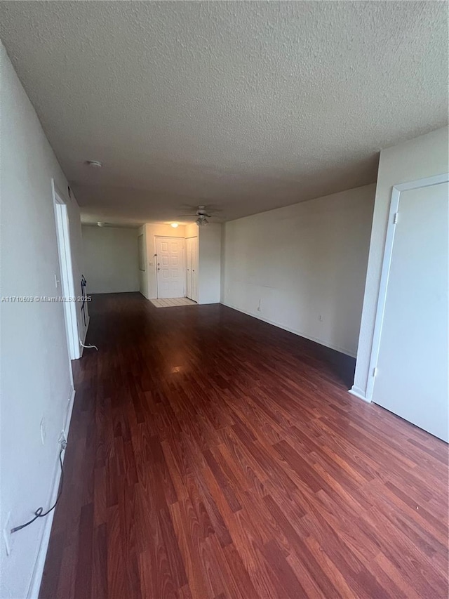 spare room featuring hardwood / wood-style flooring and a textured ceiling