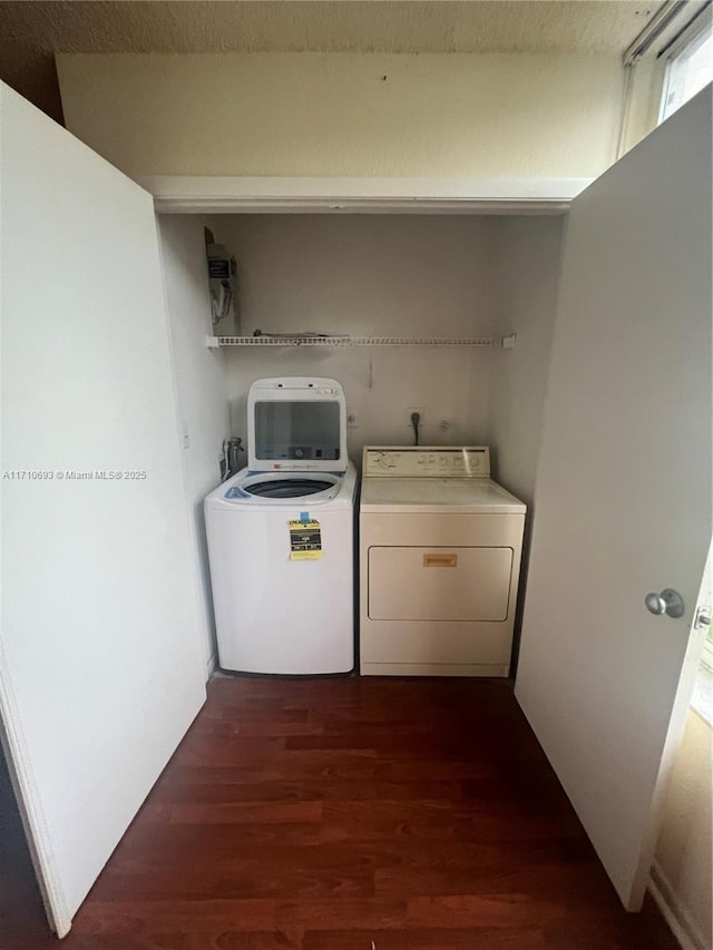 washroom featuring separate washer and dryer and dark hardwood / wood-style floors