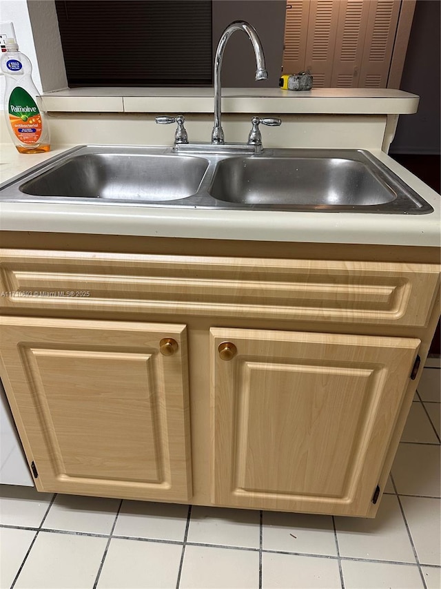 details featuring light brown cabinets and sink