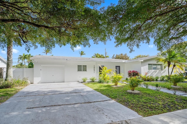 ranch-style home with a front lawn and a garage