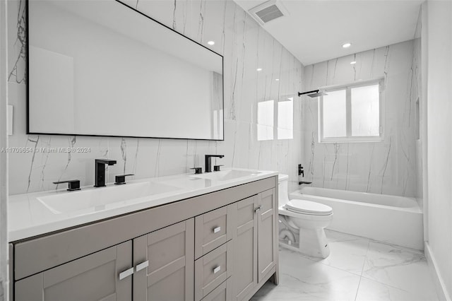 full bathroom featuring vanity, toilet, and tiled shower / bath