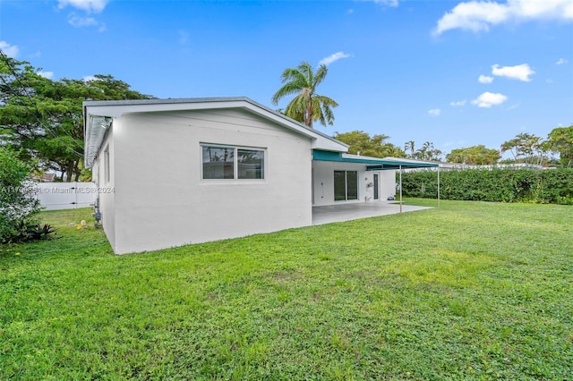 back of house featuring a yard and a patio