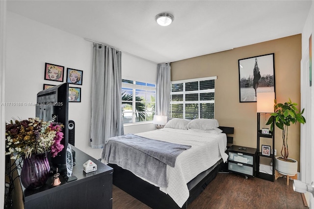 bedroom with dark hardwood / wood-style floors