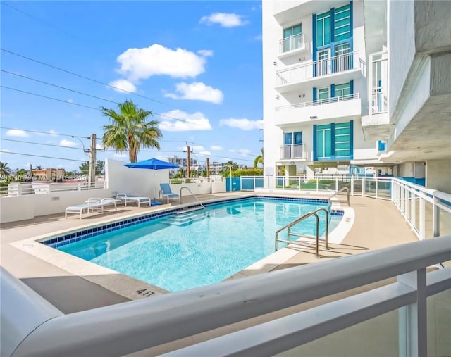 view of swimming pool featuring a patio area