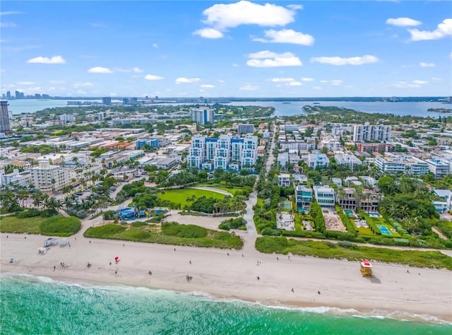 bird's eye view featuring a water view and a beach view