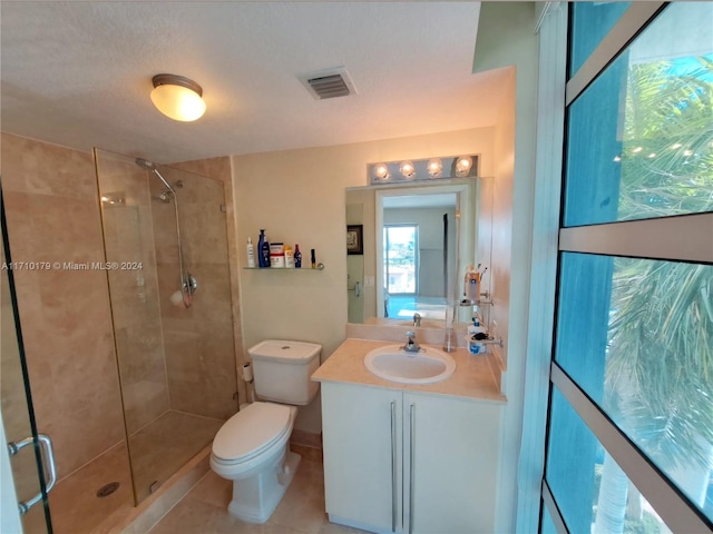 bathroom with tile patterned floors, a textured ceiling, toilet, vanity, and a shower with shower door