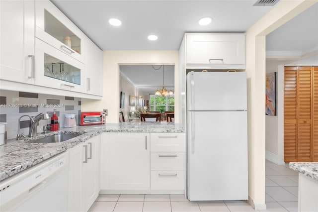 kitchen featuring white cabinets, white appliances, and ornamental molding