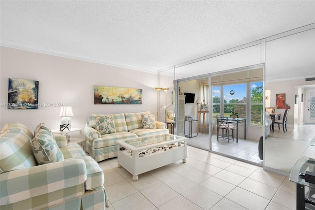 living room with light tile patterned floors, a textured ceiling, and crown molding