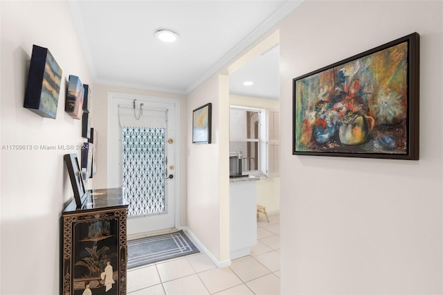 tiled foyer entrance with crown molding