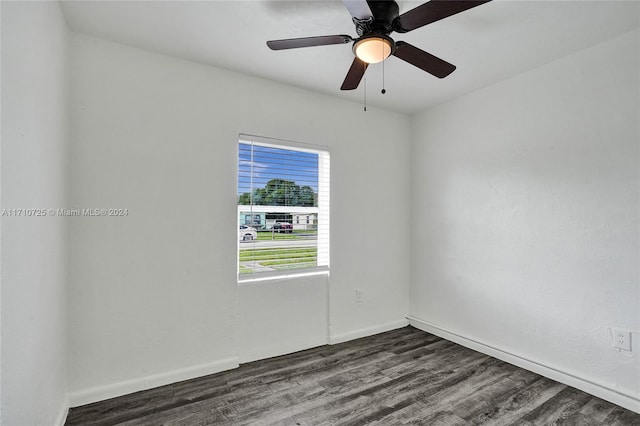 unfurnished room featuring dark hardwood / wood-style floors and ceiling fan