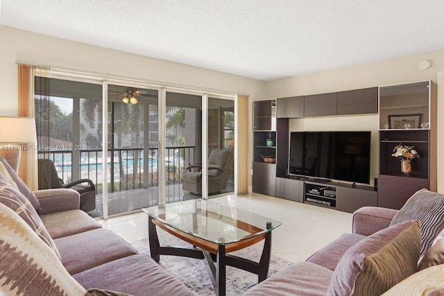 living room with light tile patterned flooring and a textured ceiling