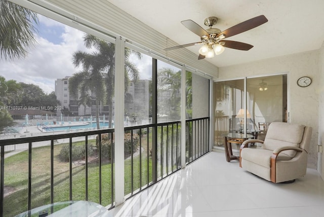 sunroom / solarium featuring ceiling fan