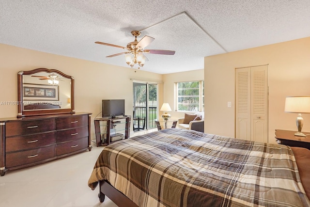 bedroom with ceiling fan, a closet, and a textured ceiling