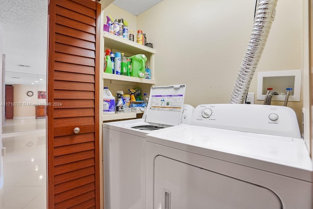 washroom with separate washer and dryer and a textured ceiling