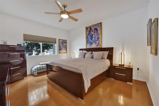 bedroom with ceiling fan and light hardwood / wood-style flooring