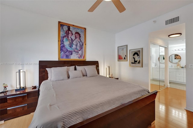 bedroom with light wood-type flooring, connected bathroom, a closet, and ceiling fan