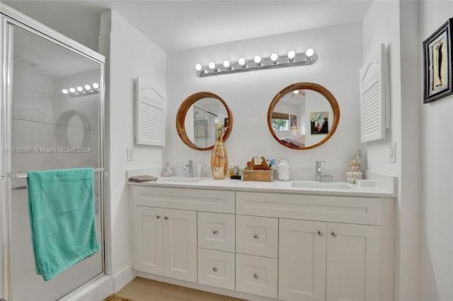 bathroom featuring vanity, tile patterned floors, and a shower with shower door