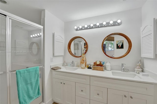 bathroom featuring vanity and a shower with door