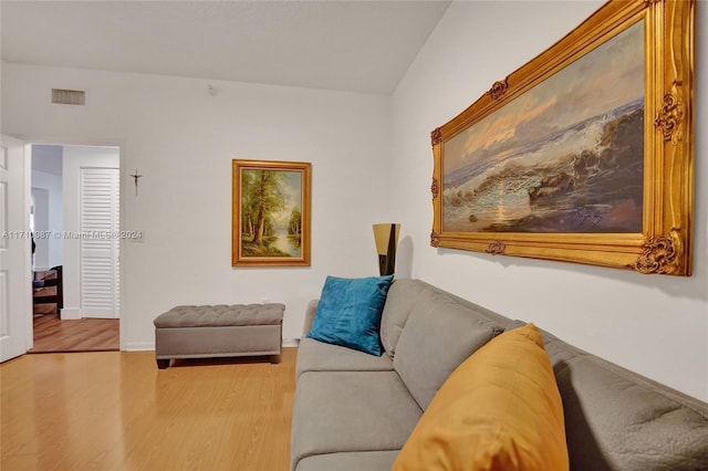 living room featuring hardwood / wood-style floors and lofted ceiling