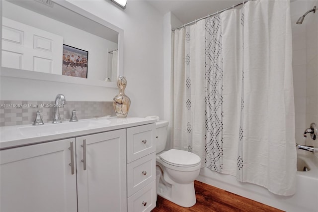 full bathroom with shower / bath combination with curtain, toilet, decorative backsplash, vanity, and hardwood / wood-style flooring