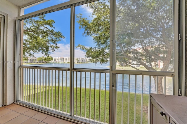 unfurnished sunroom featuring a water view and plenty of natural light