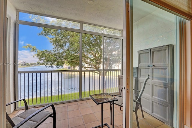 unfurnished sunroom featuring a water view