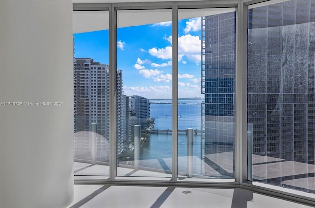 doorway featuring a water view and a wealth of natural light